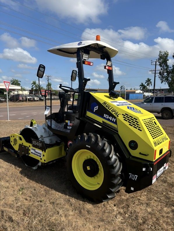 A Yellow and Black Tractor is Parked in a Parking Lot — Hire Power NT in Berrimah, NT