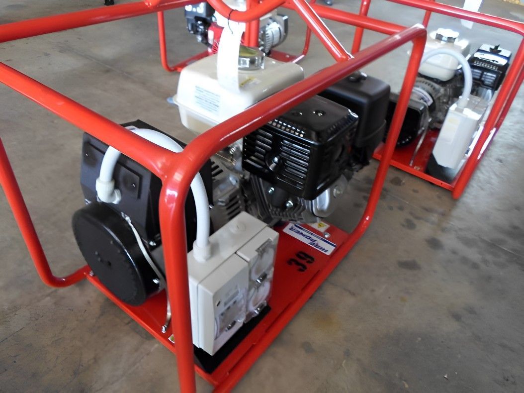 Two Engines Are Sitting in a Red Frame on a Concrete Floor — Hire Power NT in Berrimah, NT