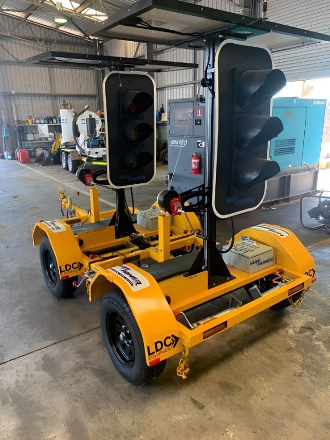 A Yellow Trailer With Two Traffic Lights Attached to It — Hire Power NT in Berrimah, NT