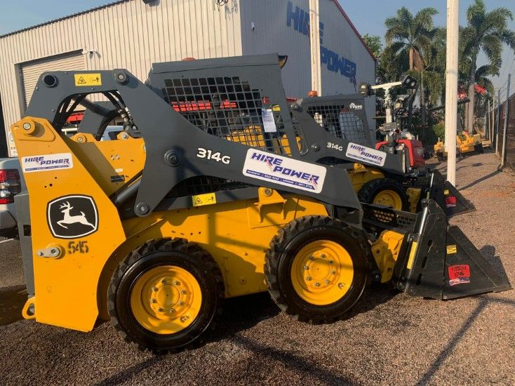 A Yellow Bulldozer is Parked in Front of a Building — Hire Power NT in Berrimah, NT