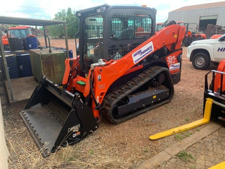 A Bulldozer is Parked in a Parking Lot With a Forklift Attached to It — Hire Power NT in Berrimah, NT