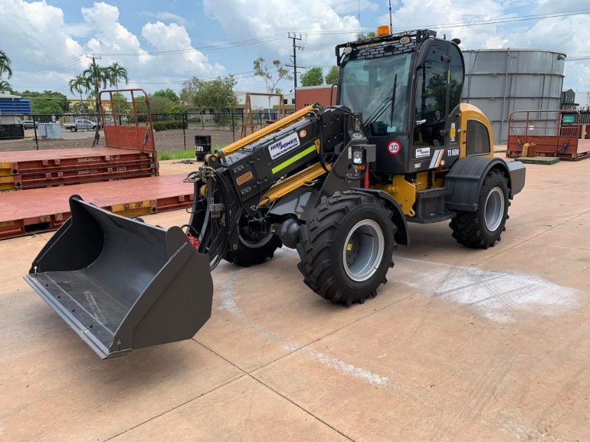 A Yellow and Black Tractor With a Large Bucket is Parked — Hire Power NT in Berrimah, NT