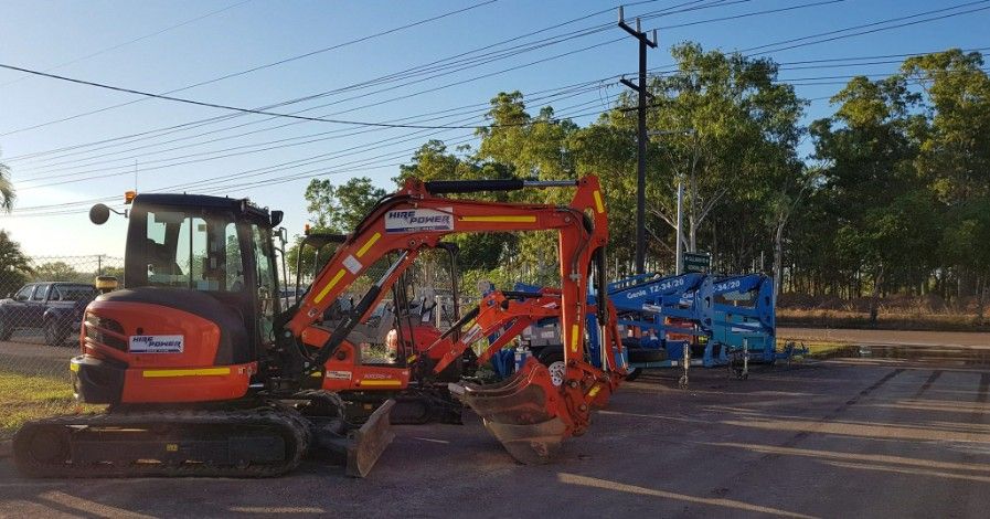 A Small Orange Excavator is Parked in a Parking Lot — Hire Power NT in Berrimah, NT