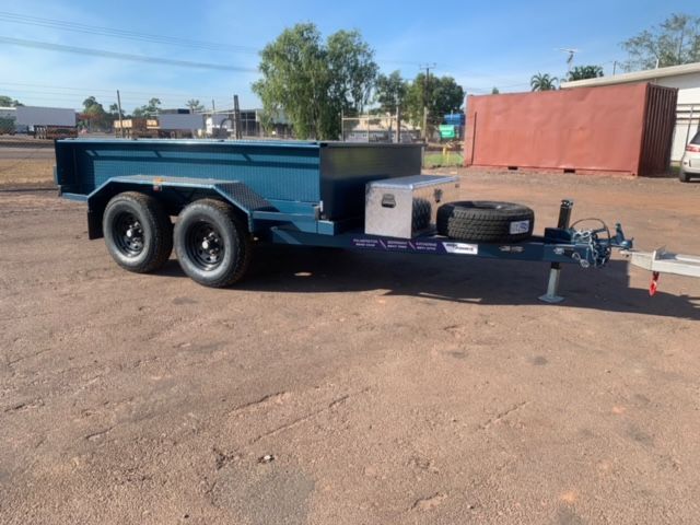 An Excavator is on a Trailer in Front of a Building That Says Hire Power — Hire Power NT in Berrimah, NT