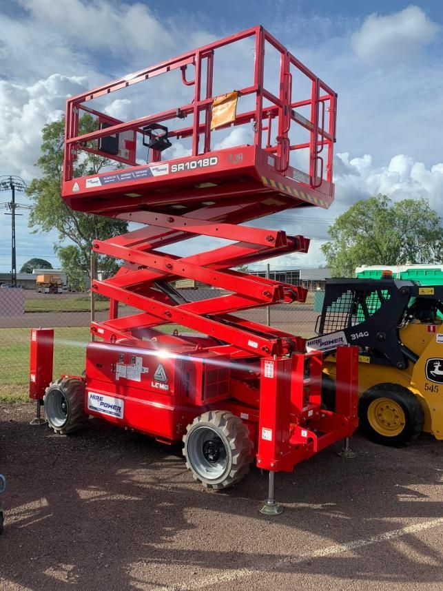 A Red Scissor Lift is Parked Next to a Yellow Forklift — Hire Power NT in Berrimah, NT