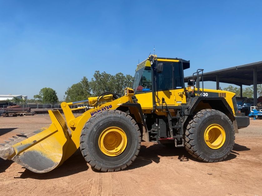 A Yellow Bulldozer Is Parked In A Dirt Lot — Advanced Weighing Technology NT Pty Ltd In Broome, WA