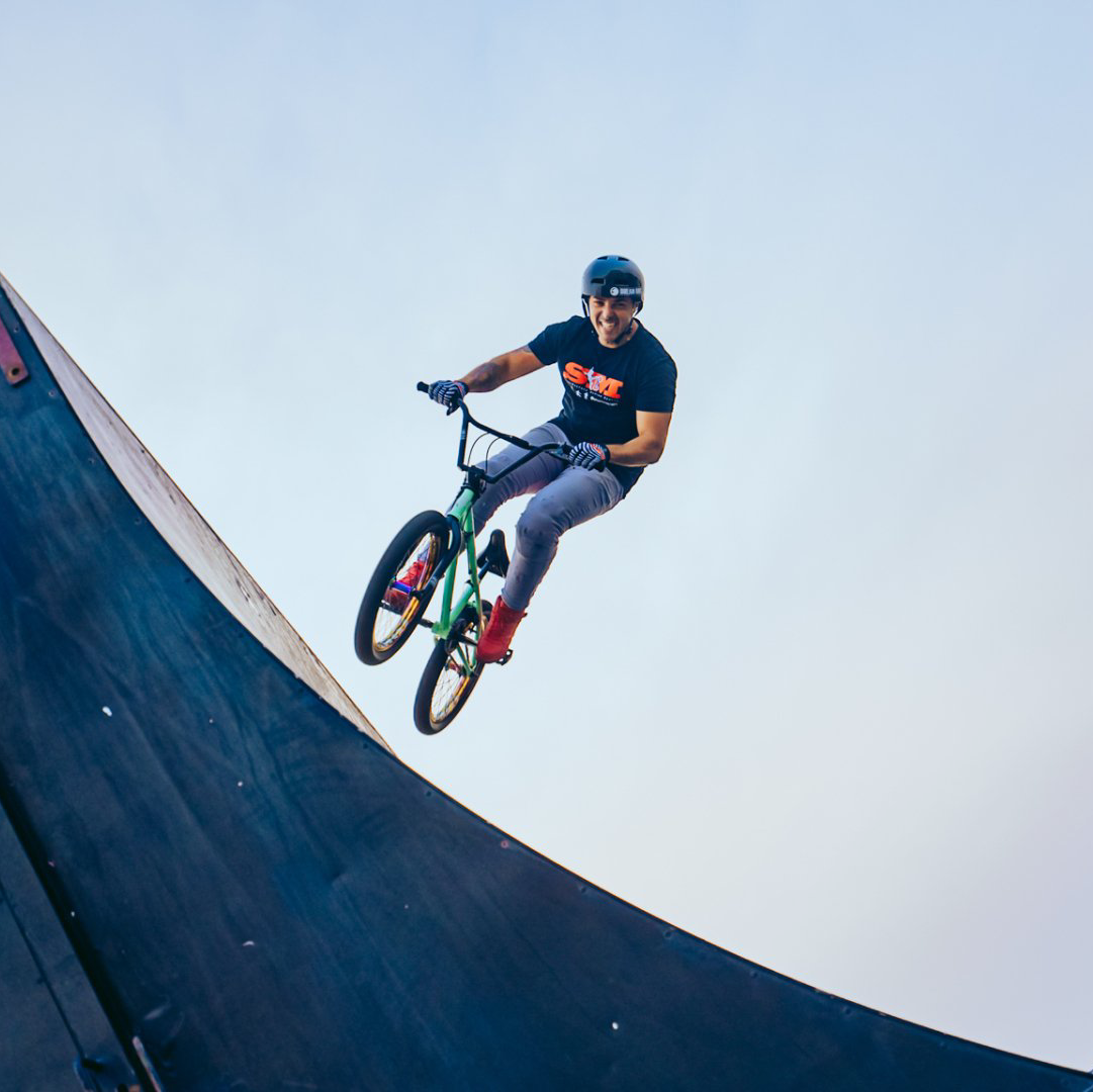 A man is riding a bike on a ramp in the air