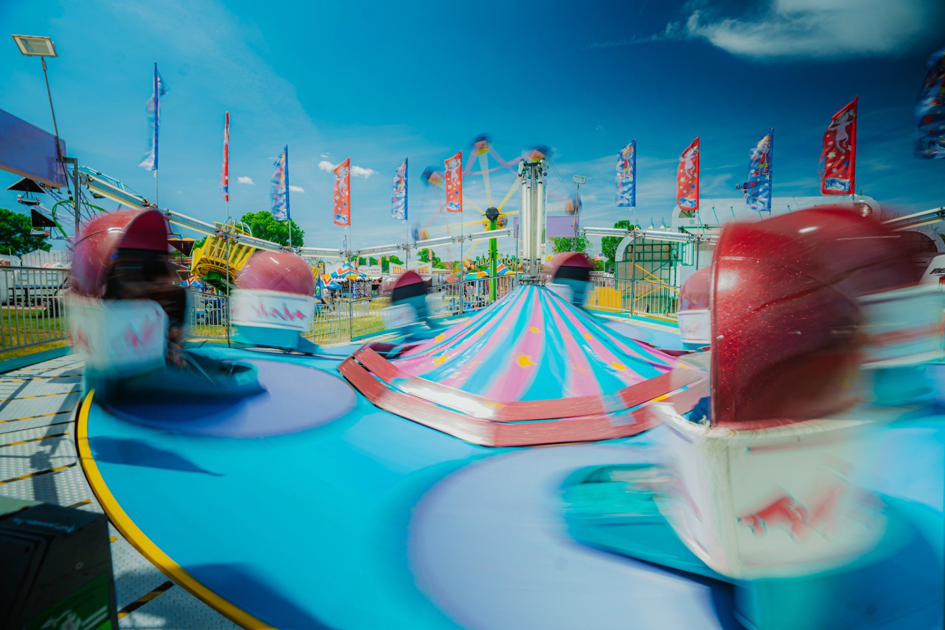 A group of people are riding a roller coaster at an amusement park.