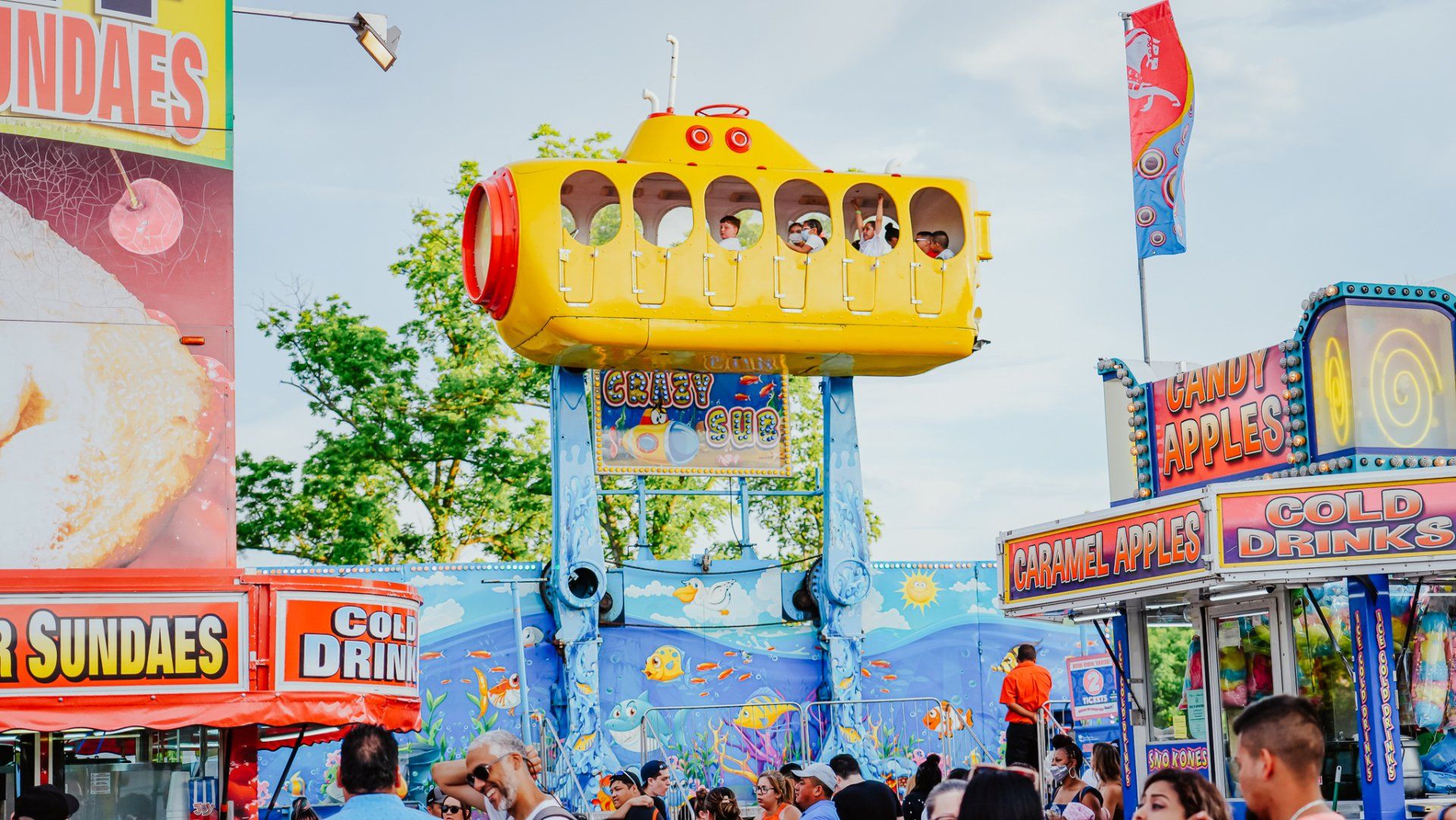 A group of people are riding a submarine ride at a carnival.