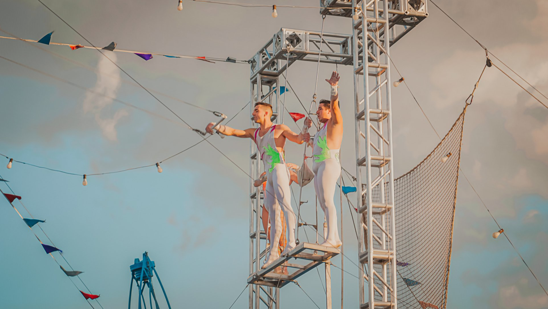 A couple of people are standing on top of a metal structure.
