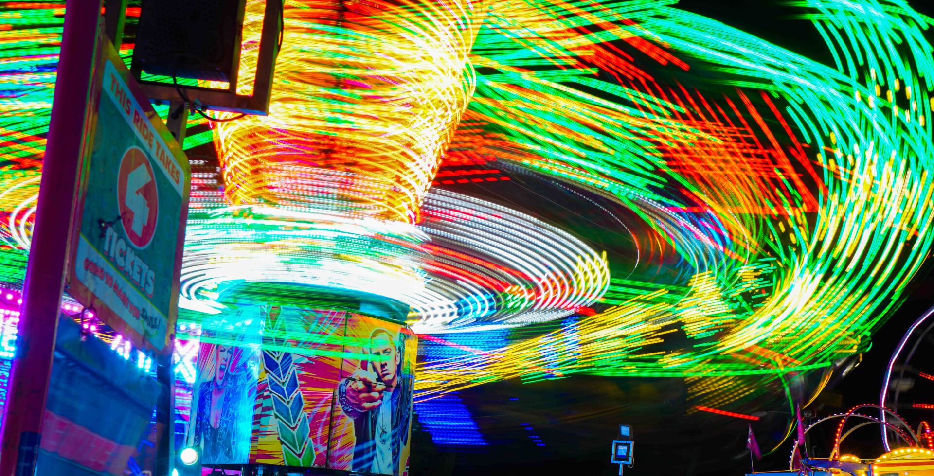 A long exposure photo of a carnival ride at night.