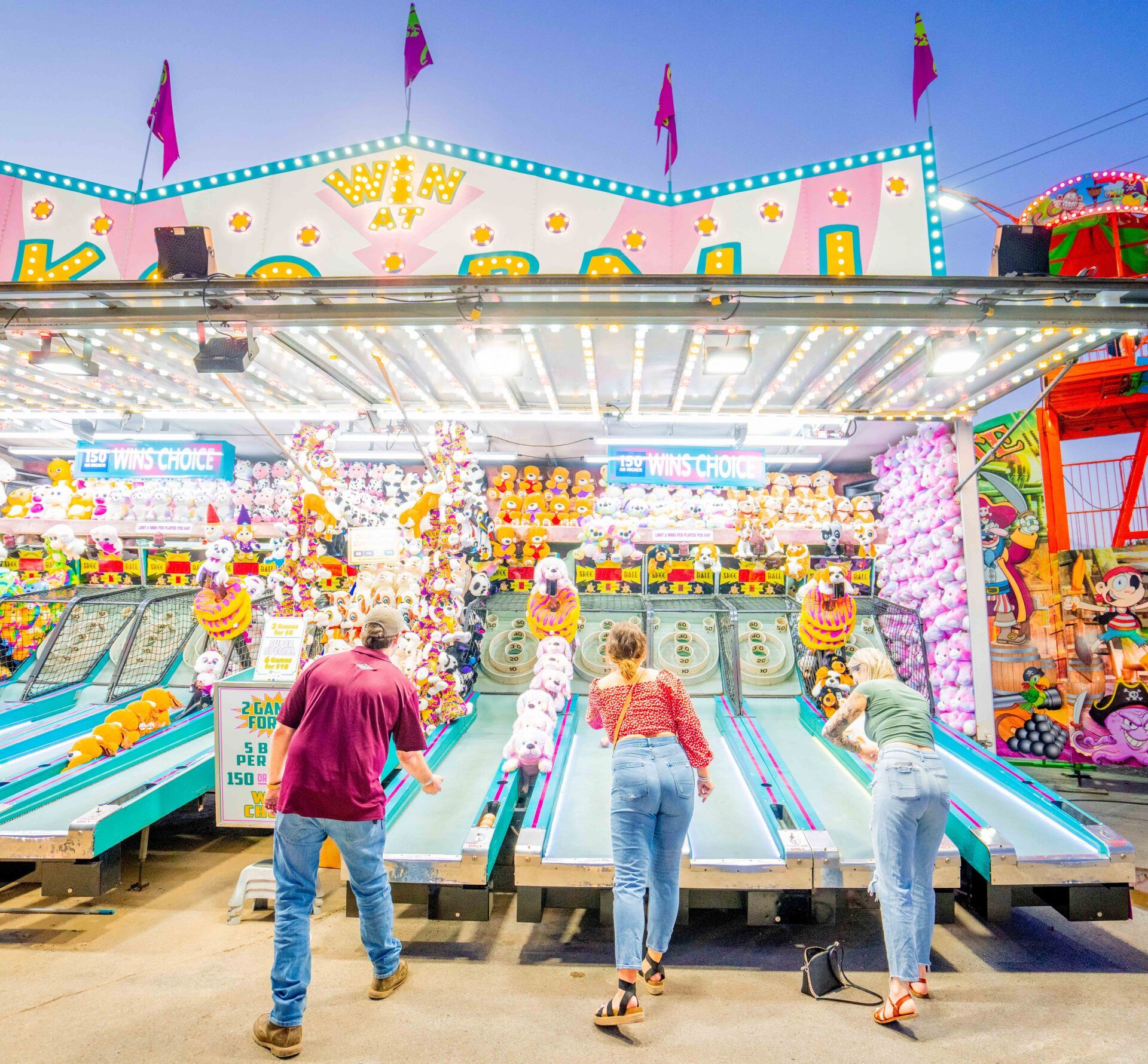 A group of people are playing a game at a carnival.
