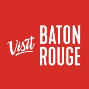 A red and white logo for visit baton rouge