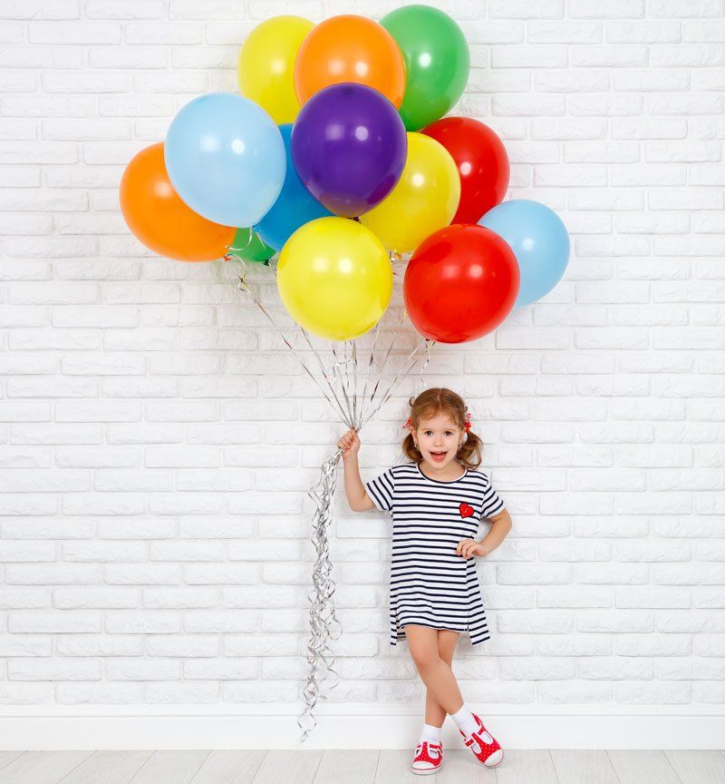 Happy Little Girl Holding Balloons