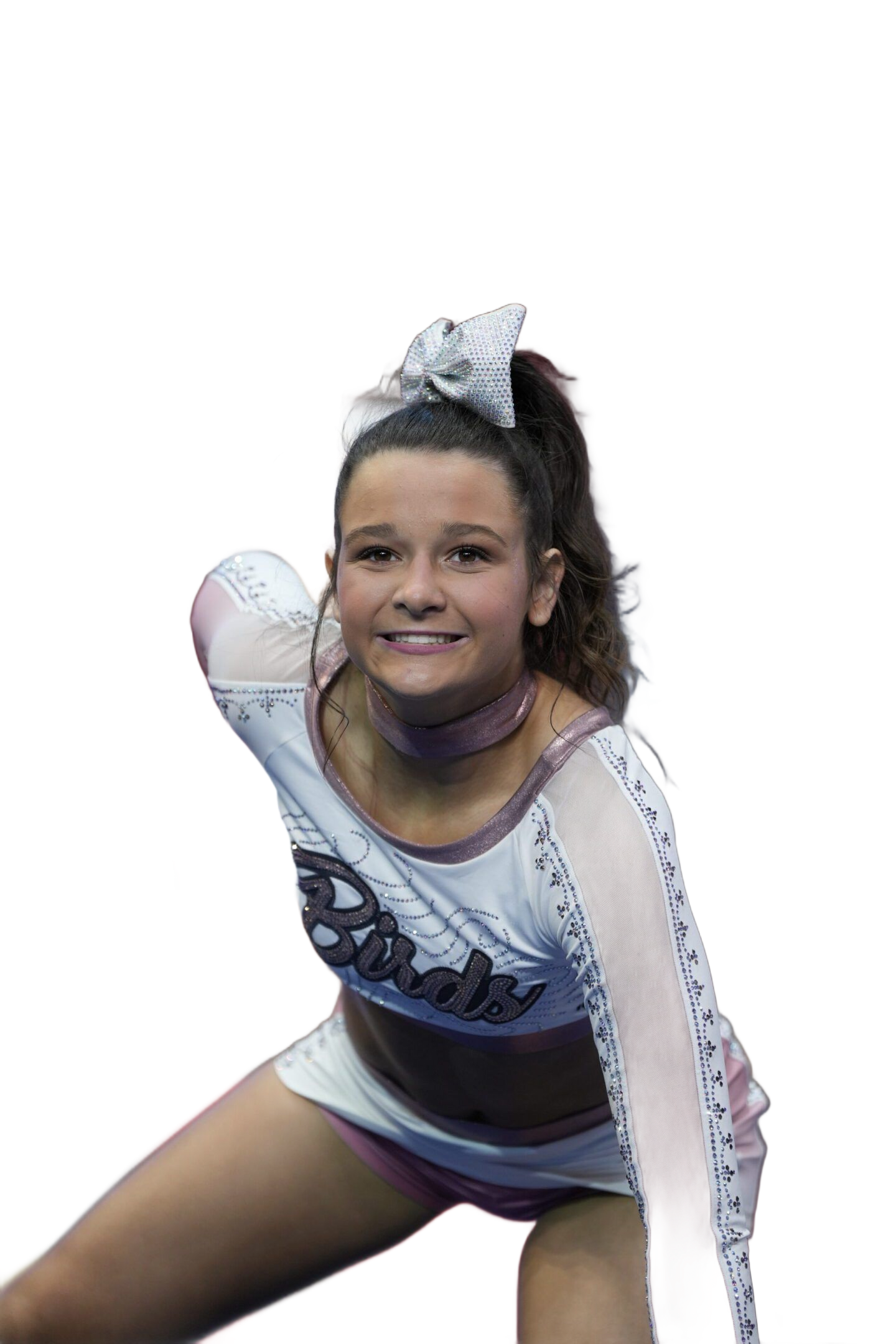 A cheerleader in a white uniform with silver details and a matching bow, smiling while in a dynamic athletic stance.