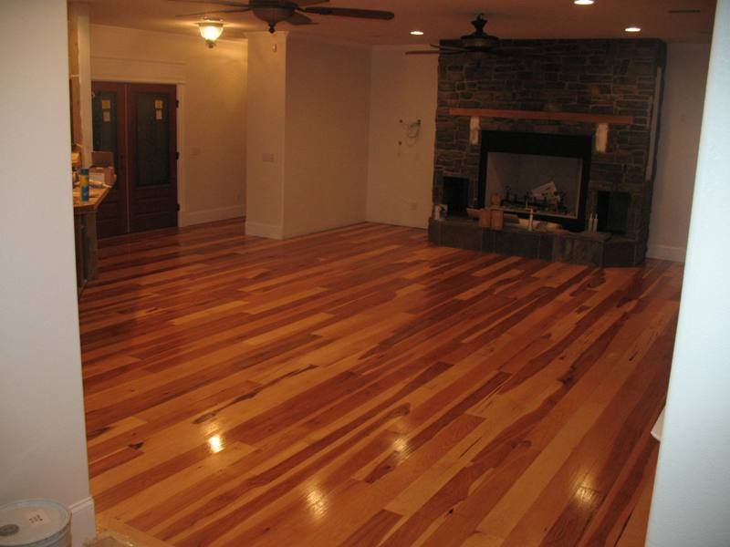 Hardwood floor in a living room with a fireplace.