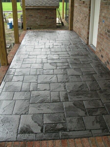 Stamped concrete patio with a dark grey stone pattern.