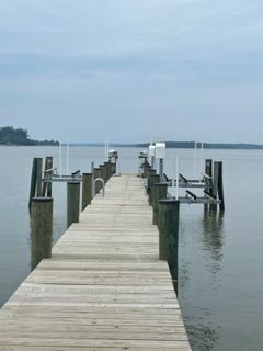 A long wooden dock leading into a body of water.