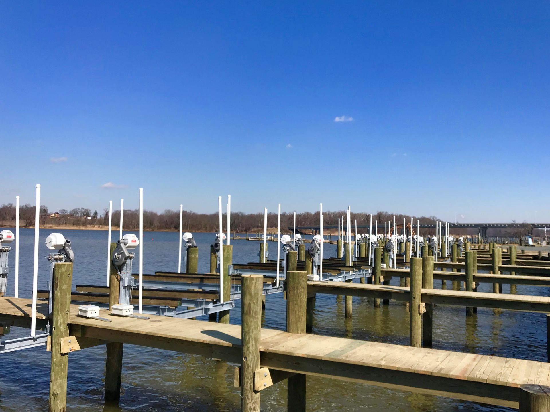 A row of wooden docks sitting on top of a body of water.