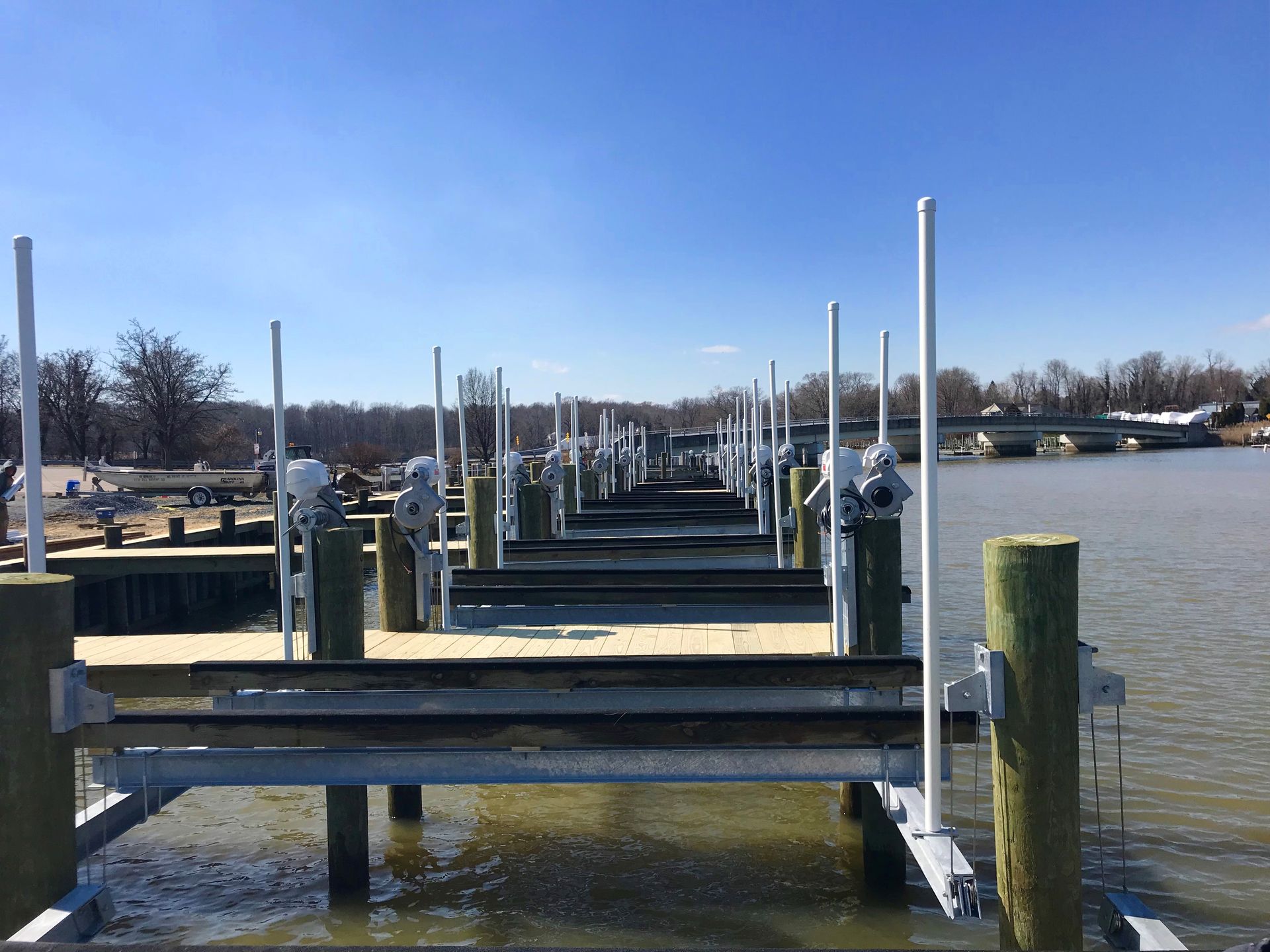 A row of dock lifts on a body of water.