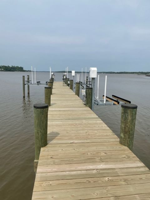 A long wooden dock in the middle of a body of water