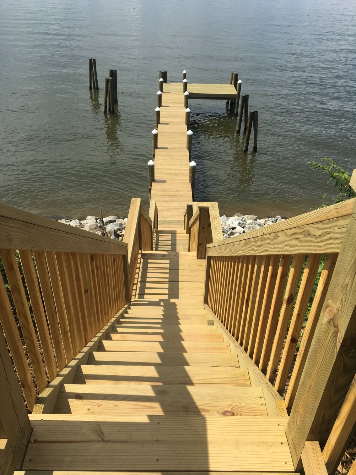 A wooden dock with stairs leading up to it