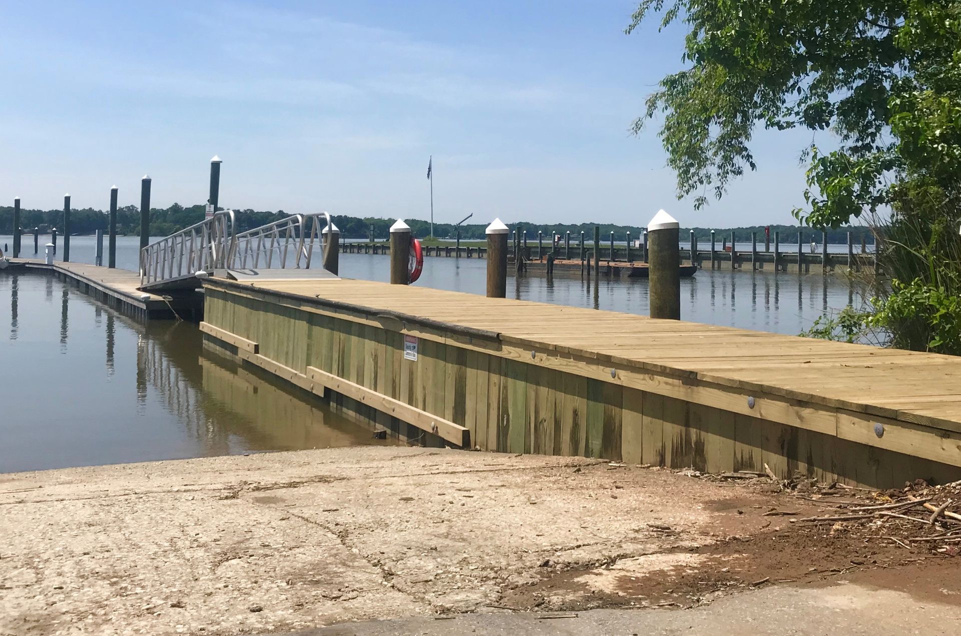 A large body of water with a wooden dock in the foreground
