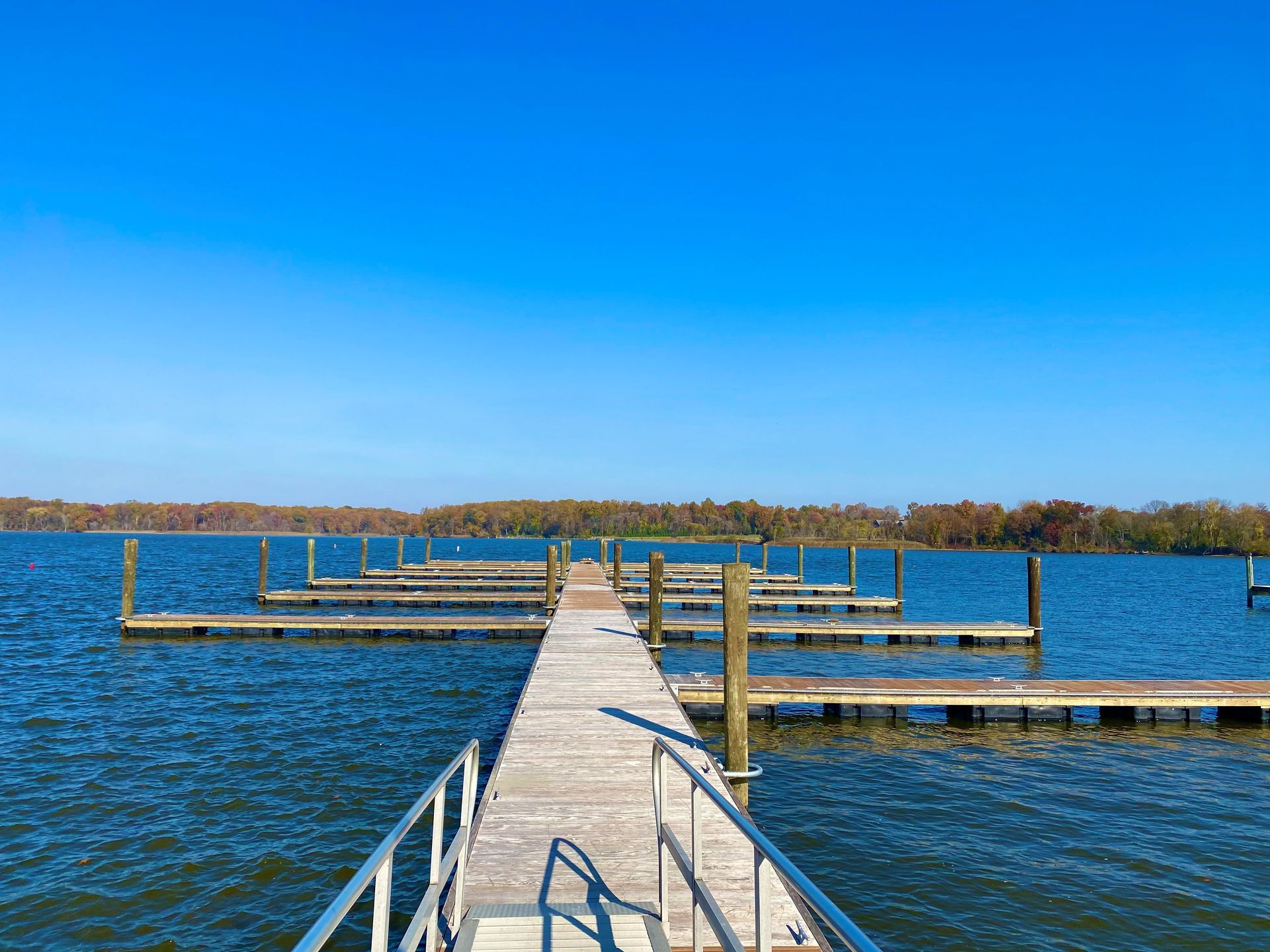 A wooden dock leading into a large body of water.