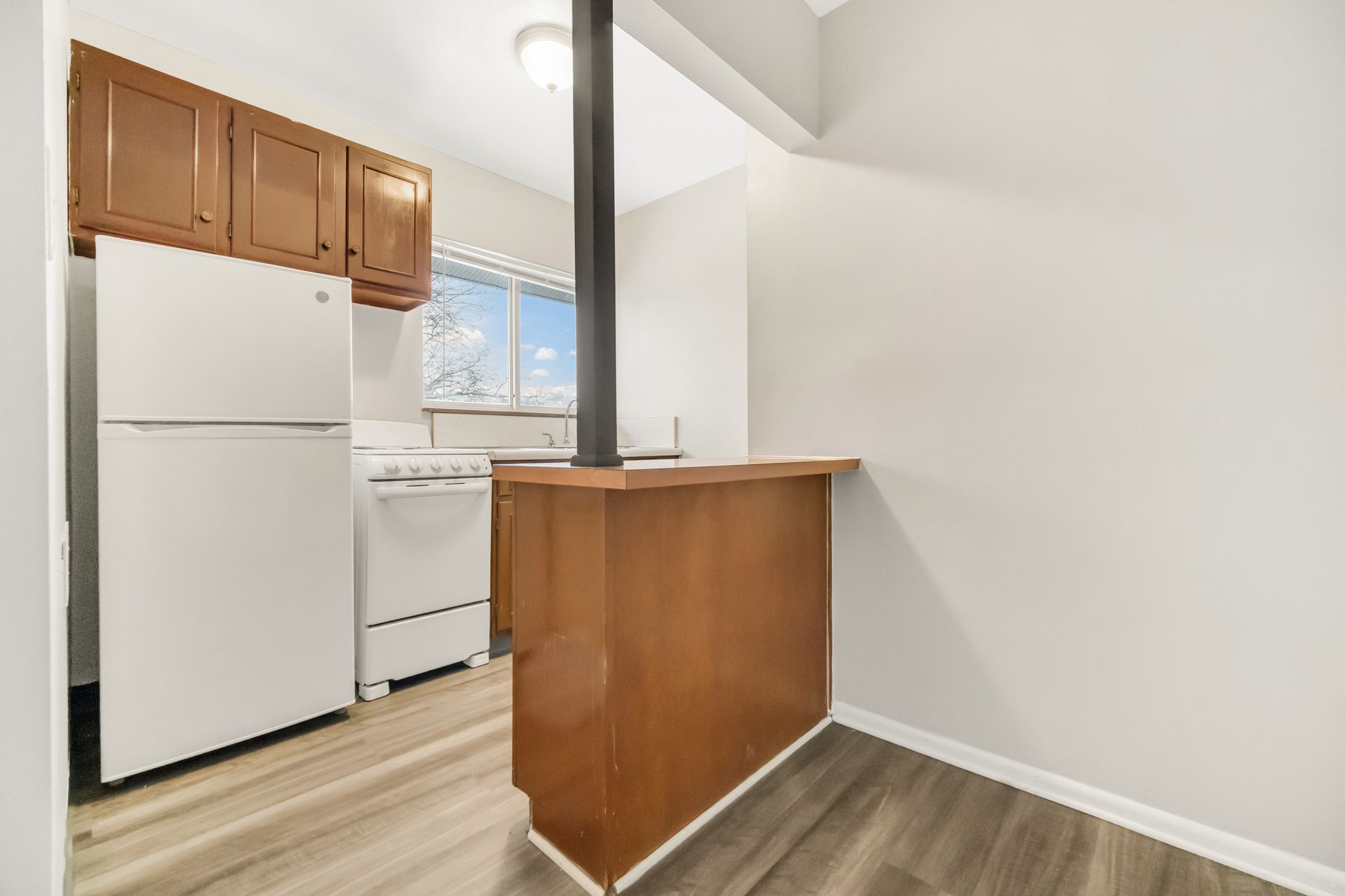 A kitchen with a refrigerator , stove , and sink.