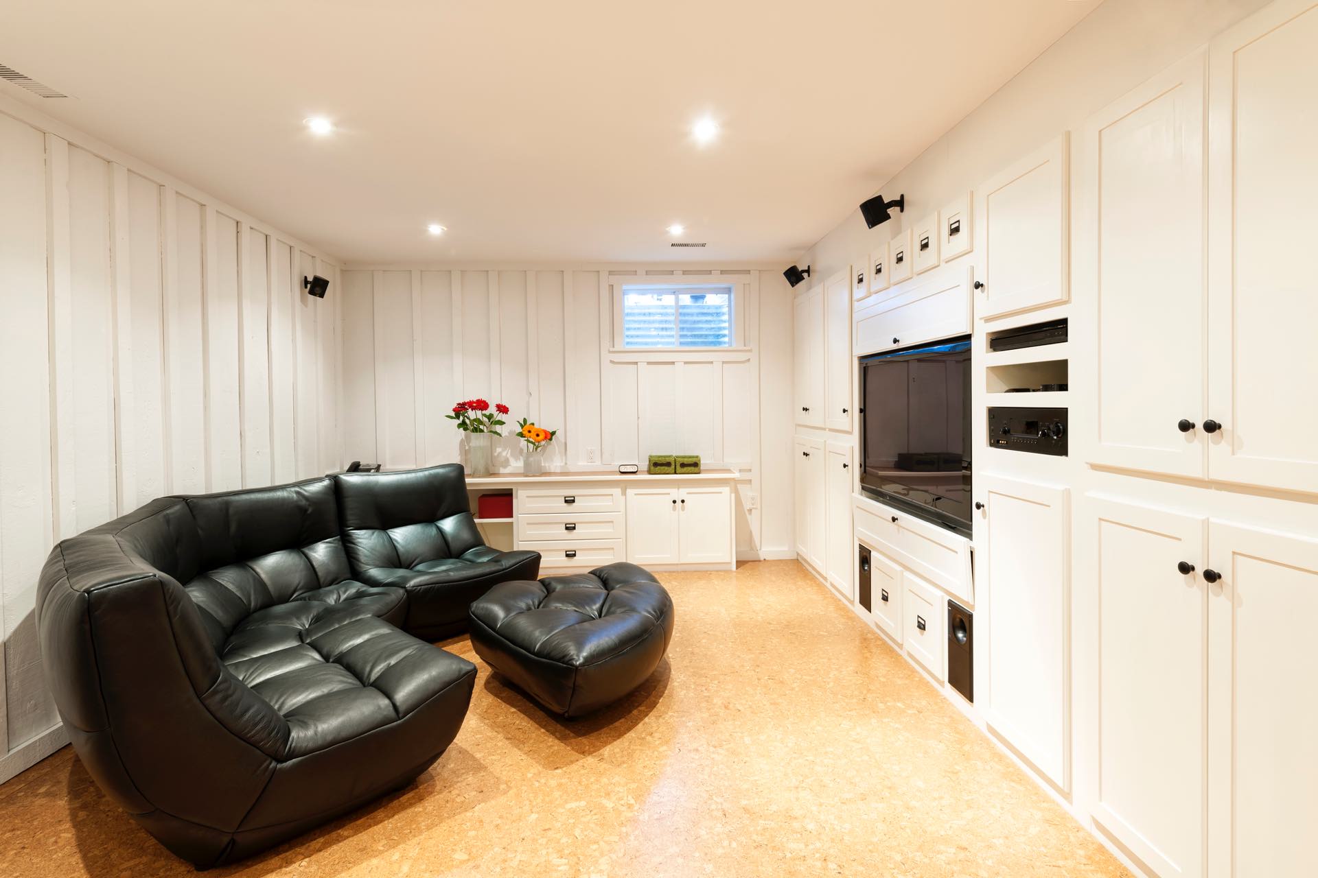 Renovate a Basement with Built-in Features and Light Colors to Make a Small Room Feel Bigger