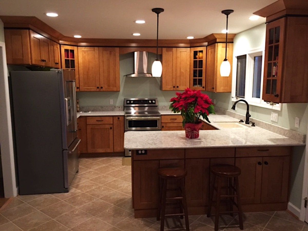 This kitchen features warm colors in the cabinets and counter tops