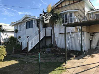 A White House with a Basketball Hoop in Front of it — Painting Services in Rockhampton, QLD