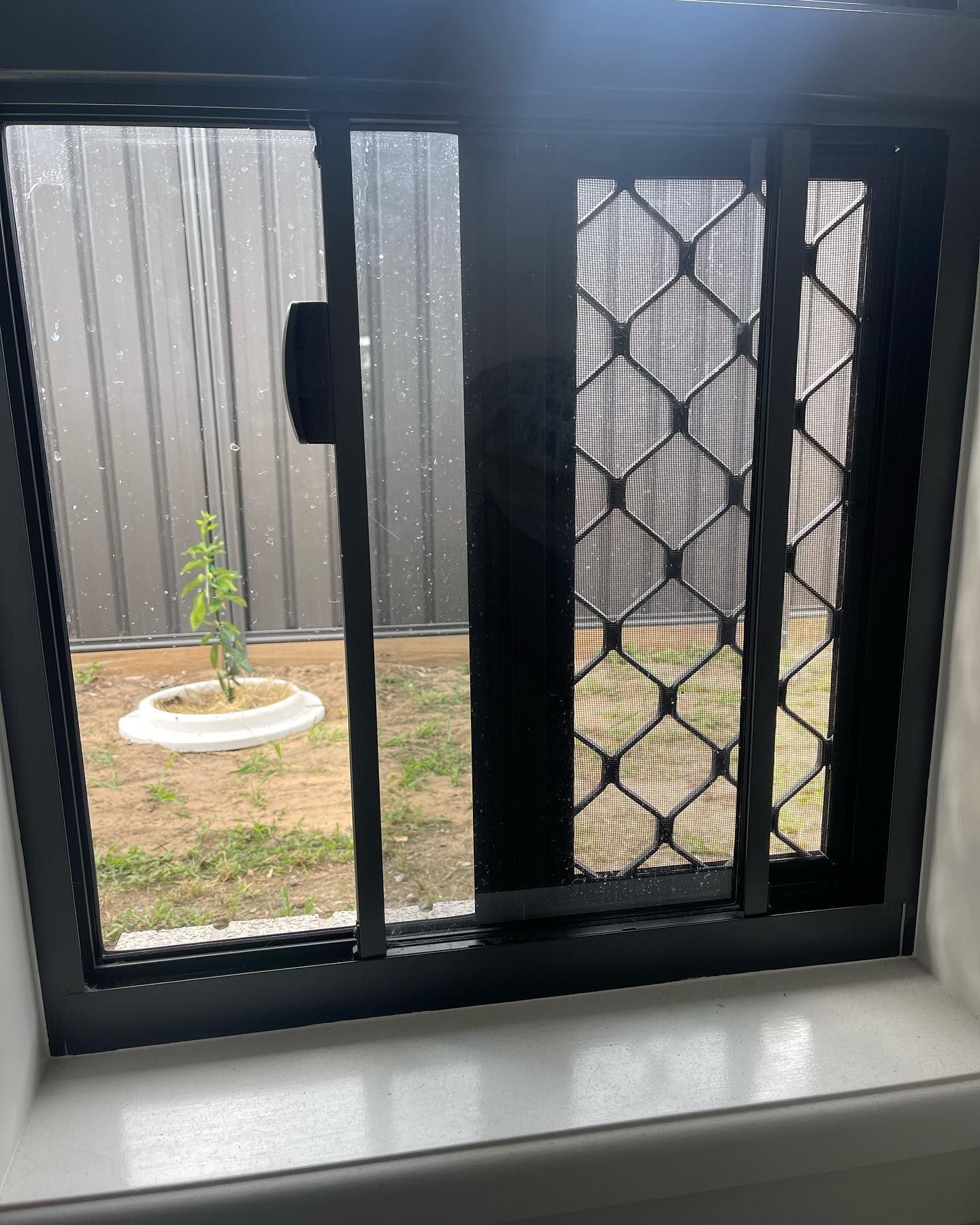 Sliding Window With Black Frame — Moore Park Beach Glass & Security in Moore Park Beach, QLD
