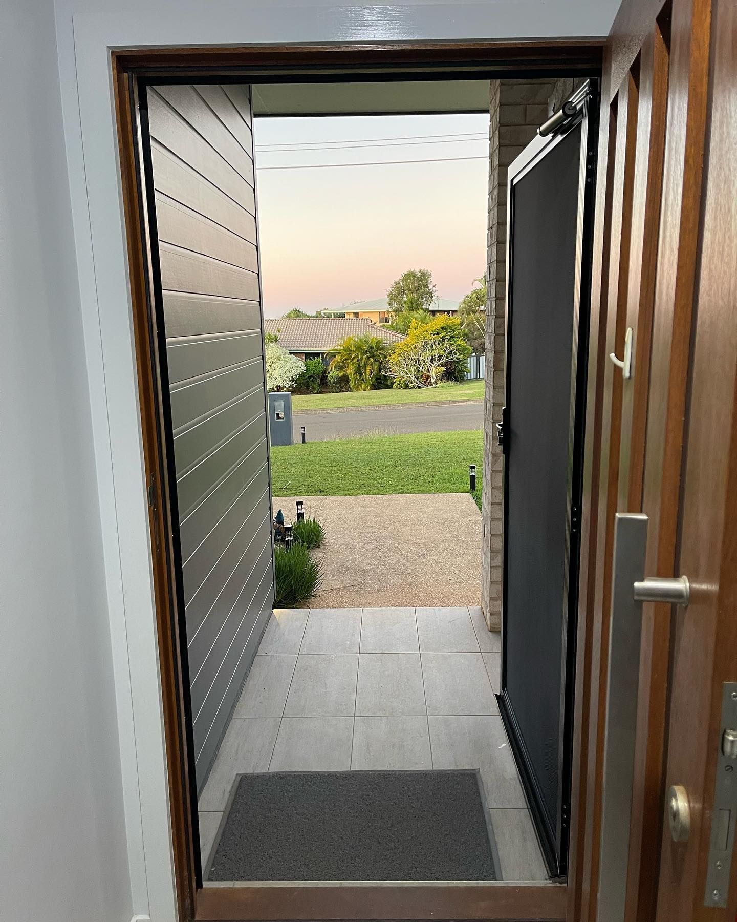 Open Doorway With Screen Door — Moore Park Beach Glass & Security in Moore Park Beach, QLD