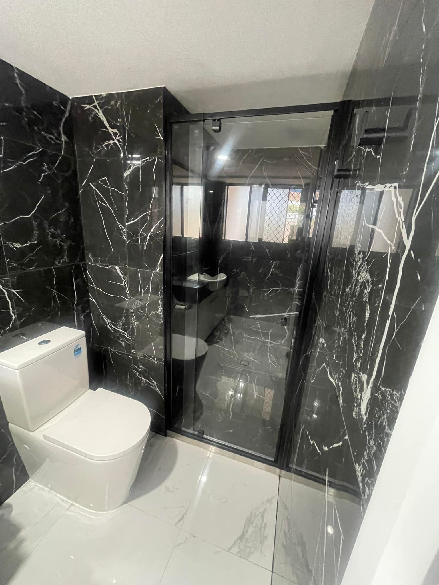 Modern Bathroom With Black Marble Tile Walls — Moore Park Beach Glass & Security in Moore Park Beach, QLD