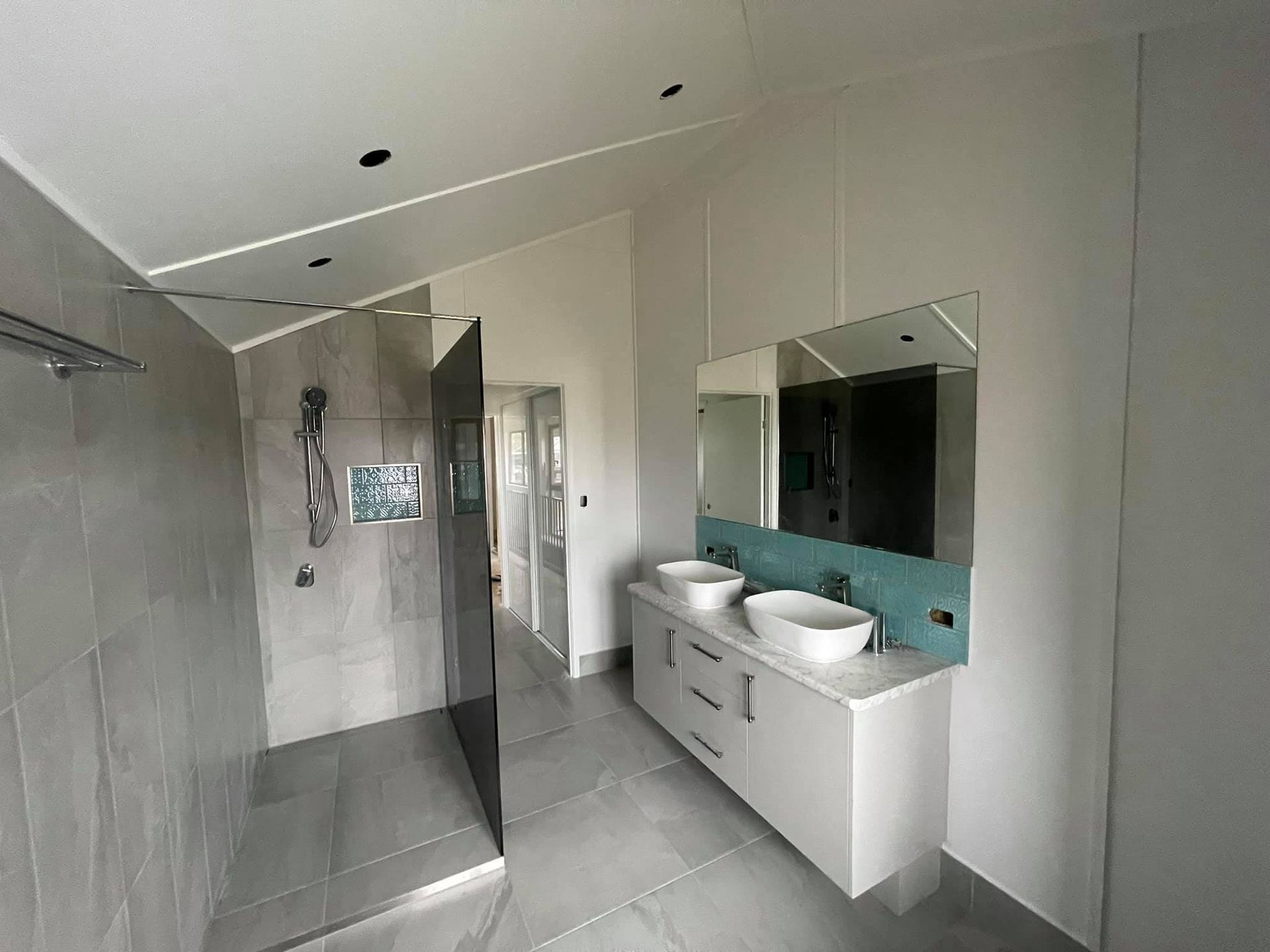 Bathroom With a Walk in Shower With a Glass Door — Moore Park Beach Glass & Security in Burnett Heads, QLD