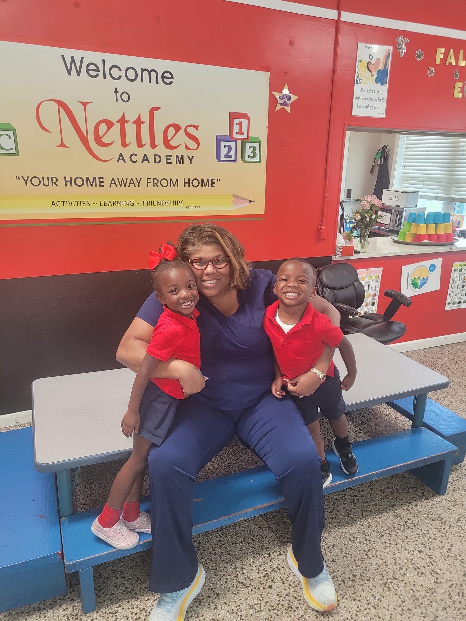 a woman is sitting on a bench with two children .