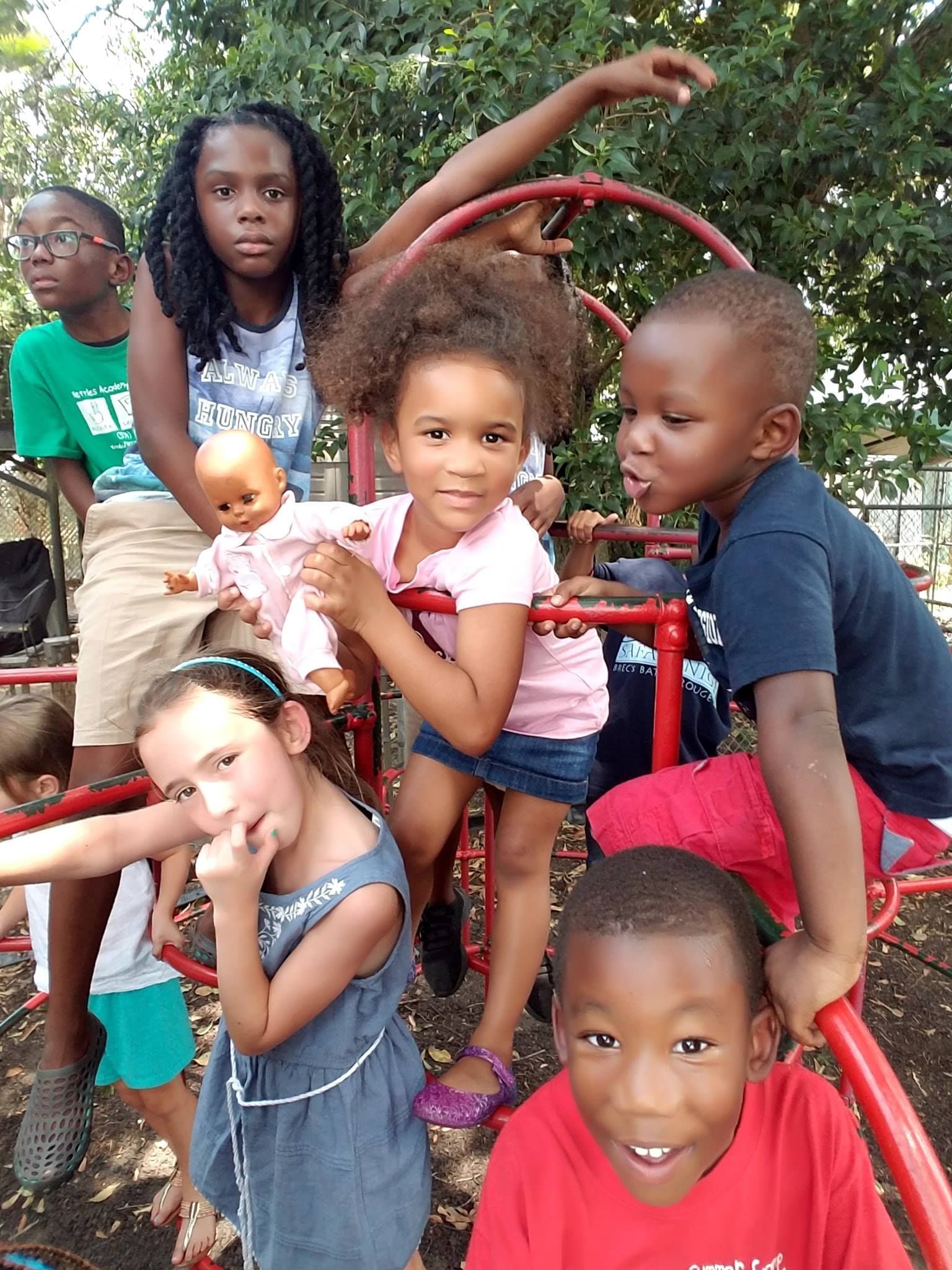 a group of children are posing for a picture on a playground
