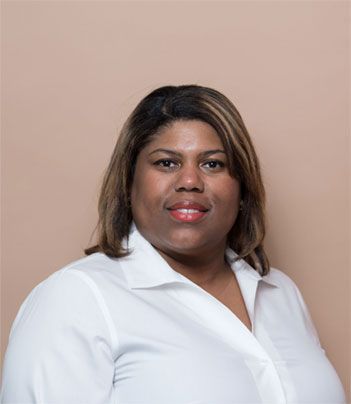 a woman in a white shirt is smiling for the camera .