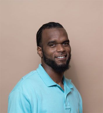 a man with a beard is wearing a blue shirt and smiling .