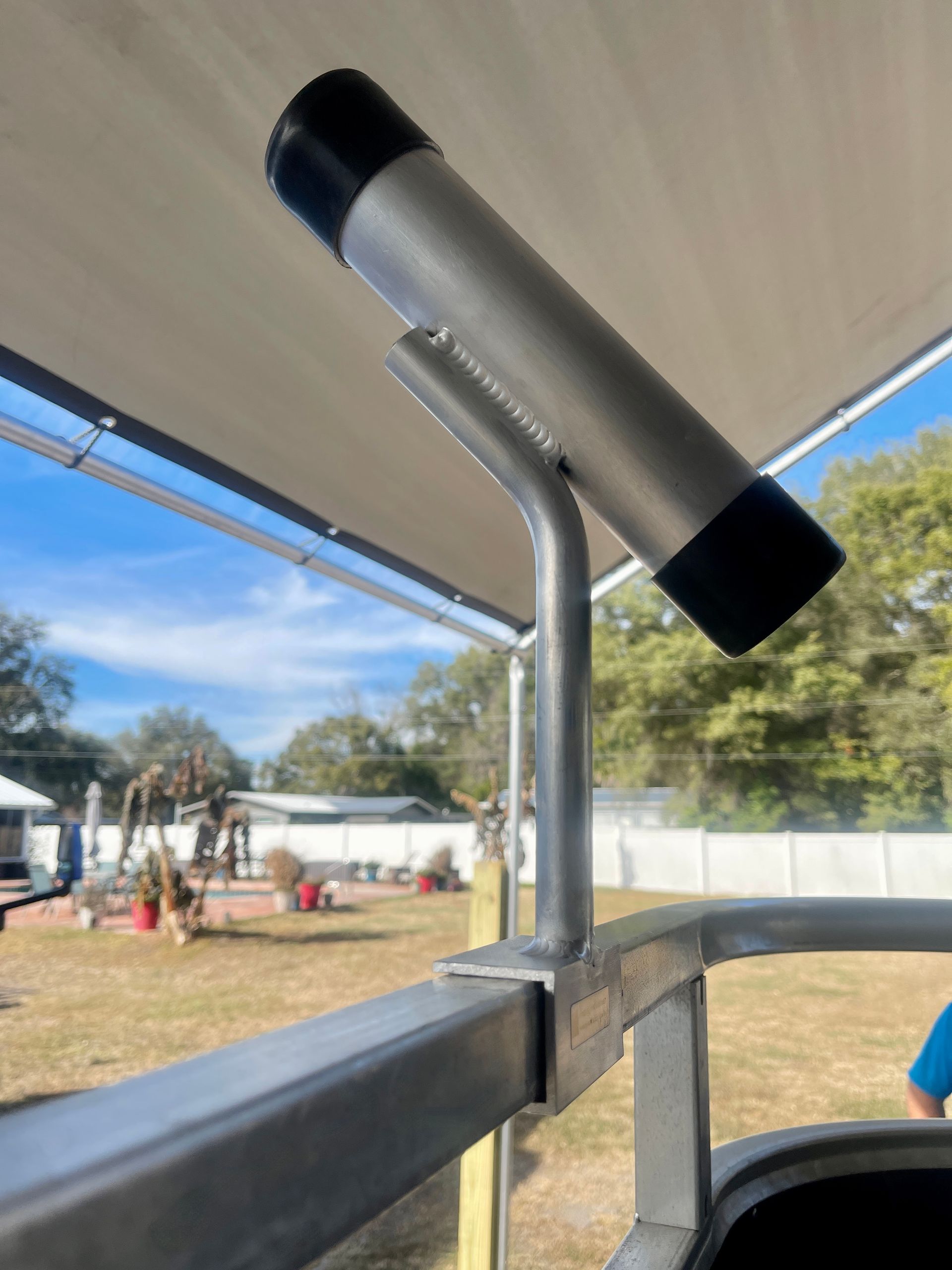 pontoon boat fishing rod holder with black ends on a small angled stand