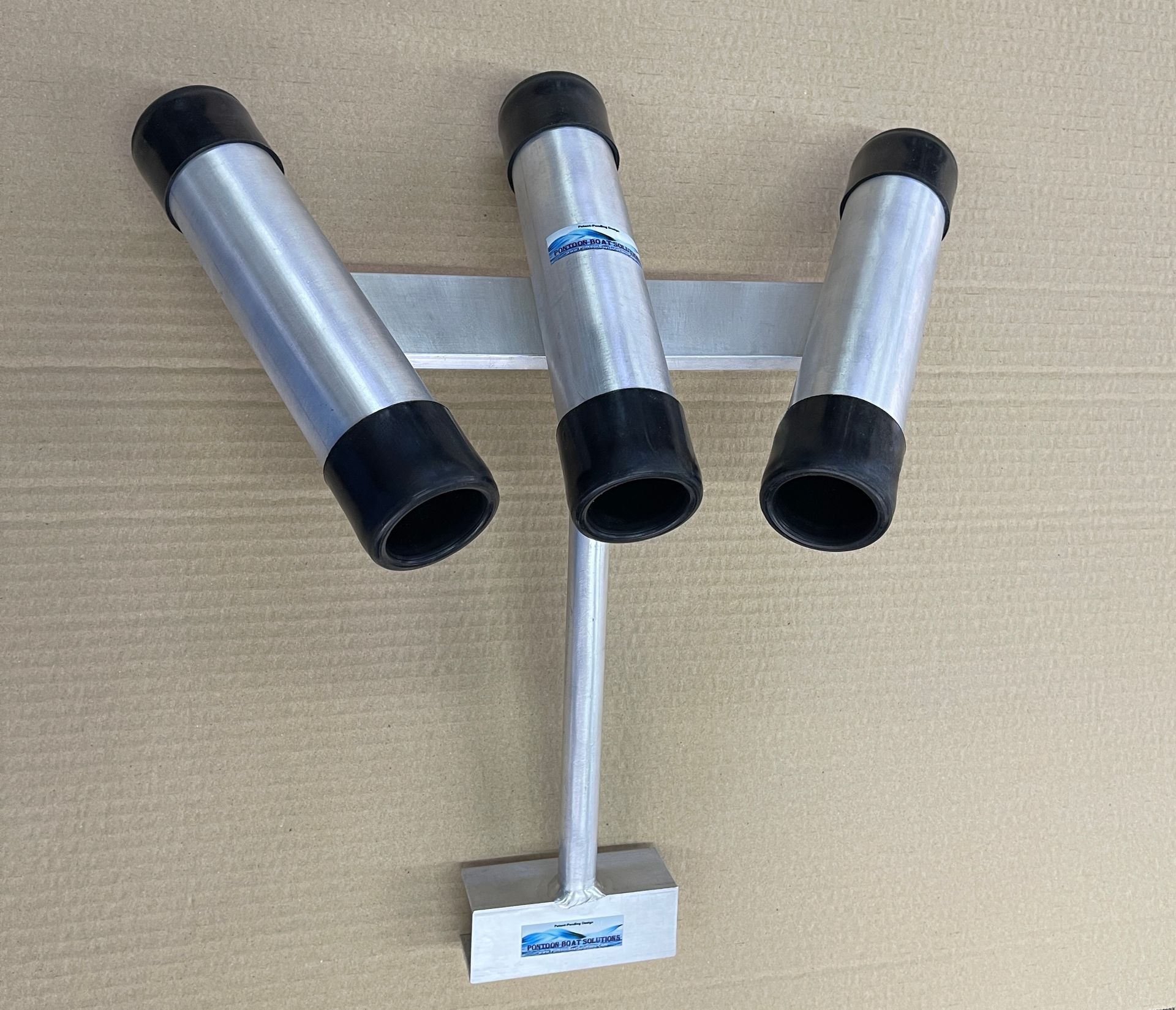 Triple fishing rod holder on a blue background with silver and black tubes