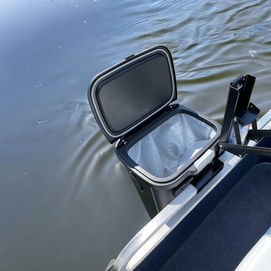 Tennis player’s legs and racket on a clay court, wearing pink shoes near the baseline