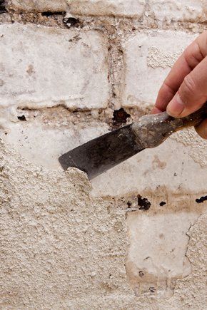 Call us now. A tradesman applying cement to bricks.