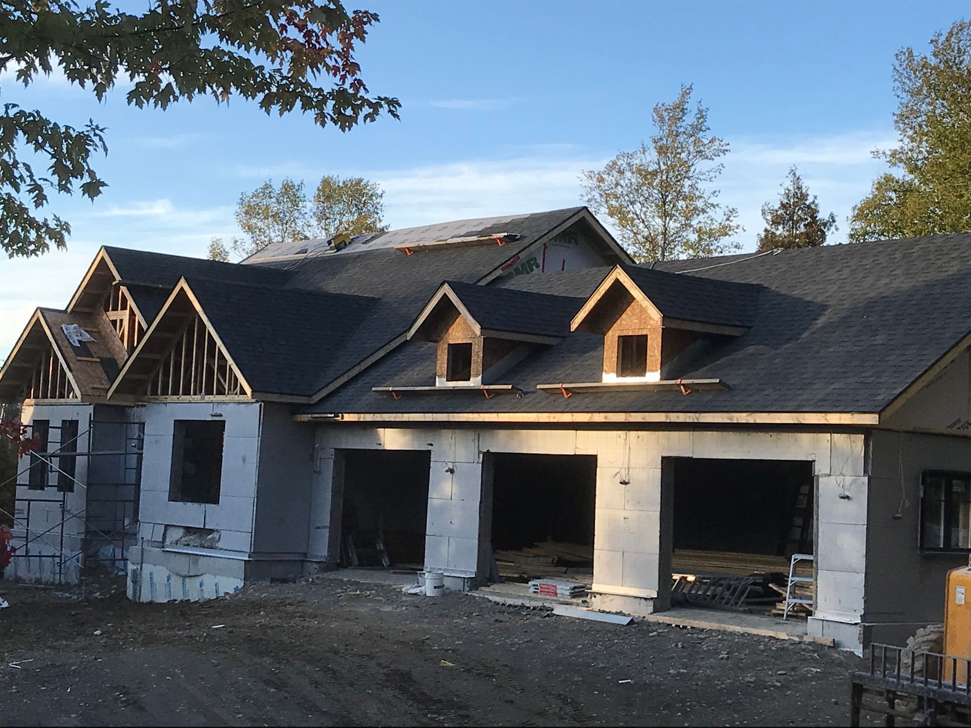 Une maison en construction avec trois garages