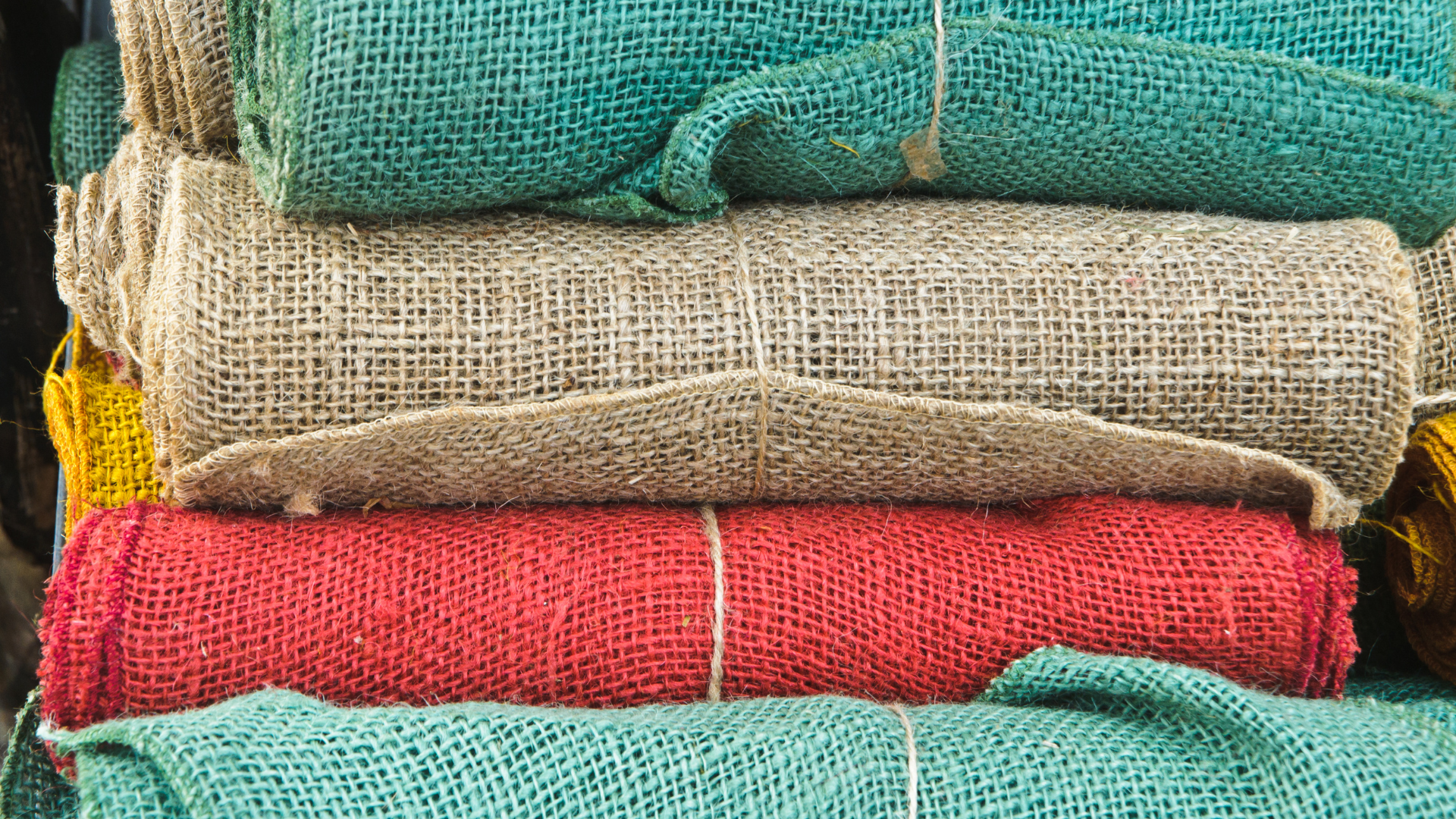 A pile of different colored fabrics stacked on top of each other.