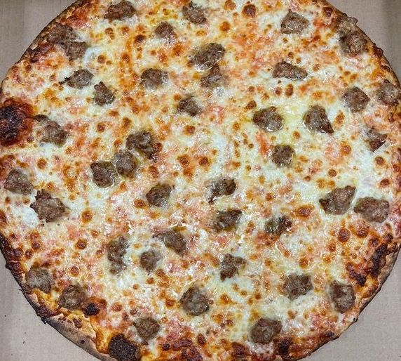 A person is taking a slice of pizza with a fork.