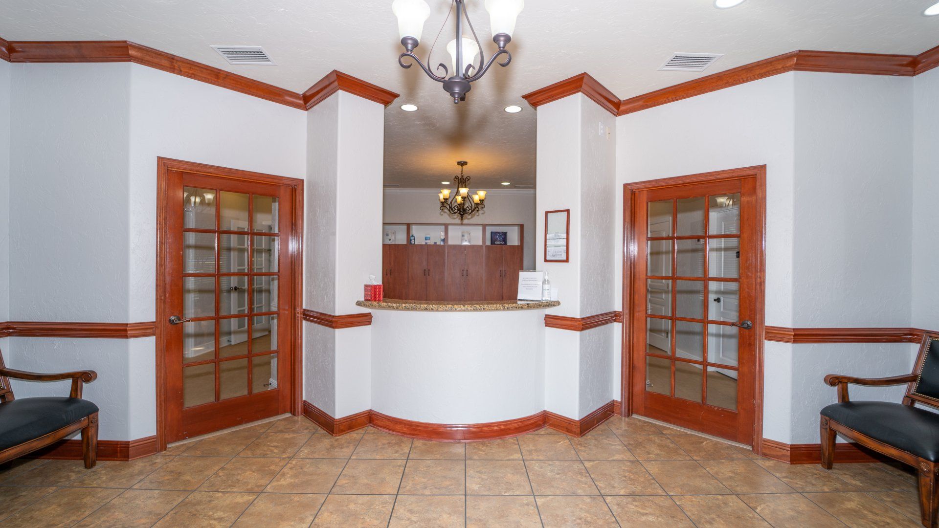 A lobby with a reception desk and chairs in it