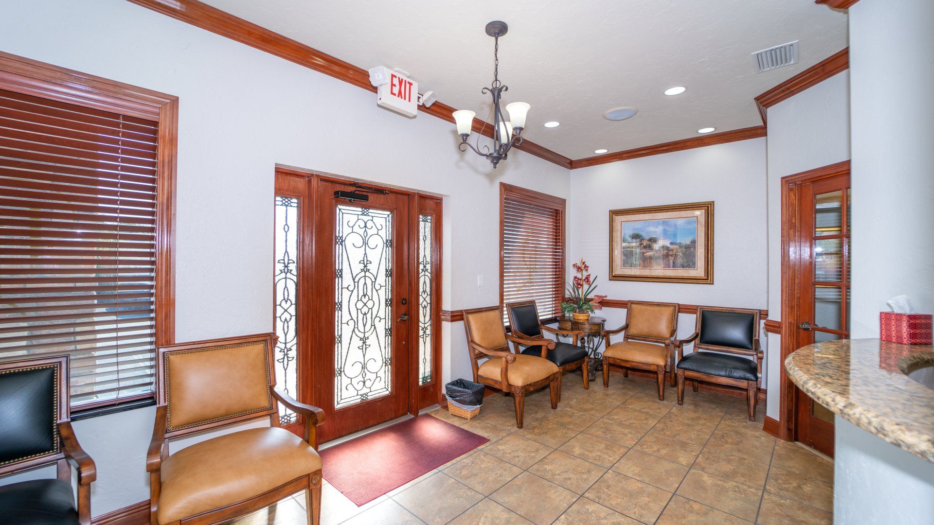 A waiting room with chairs and a sign that says exit