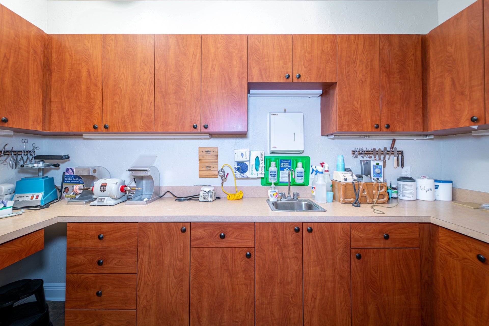 A kitchen with wooden cabinets and a sink.